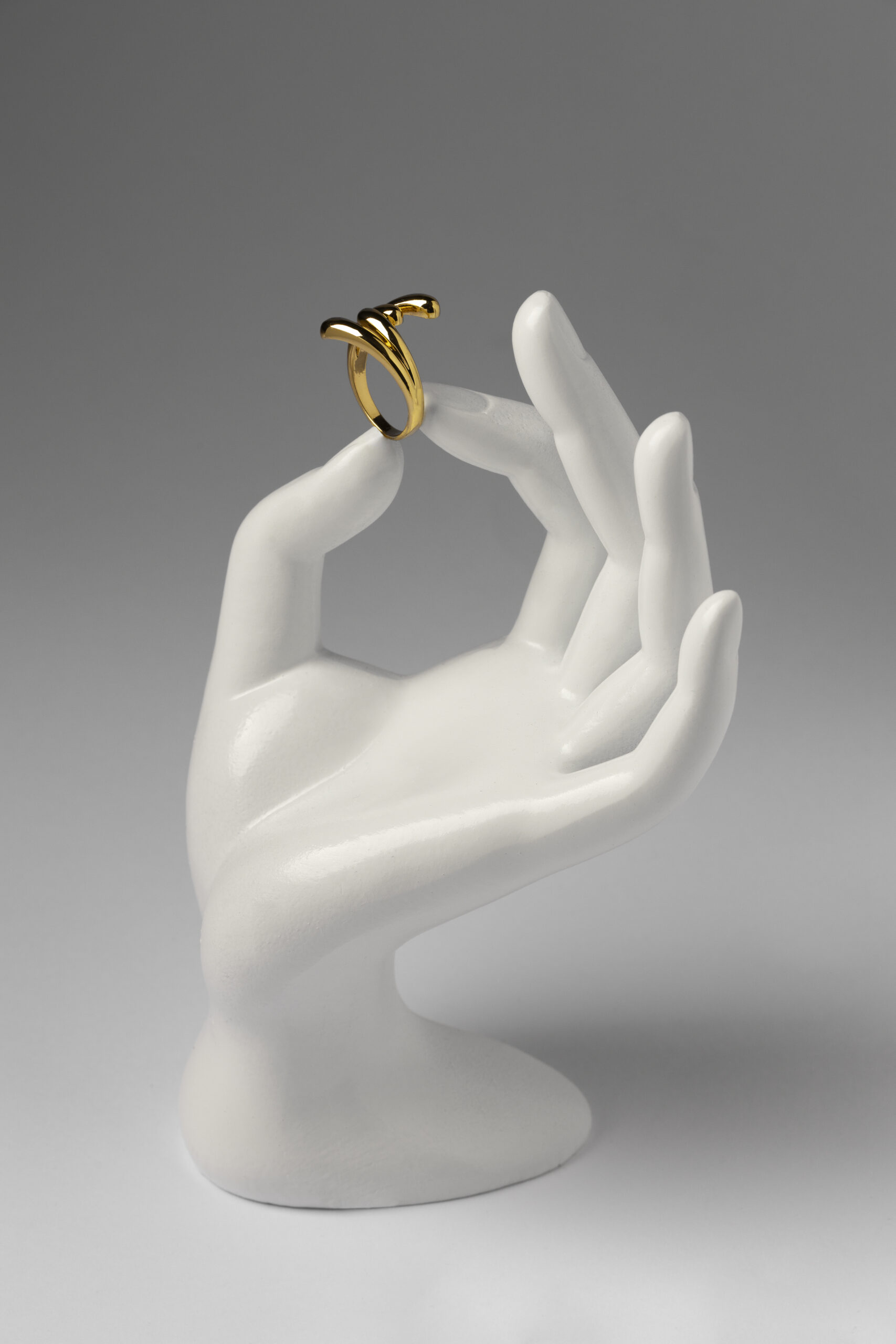 Elegant Golden Ring Displayed on a White Mannequin Hand