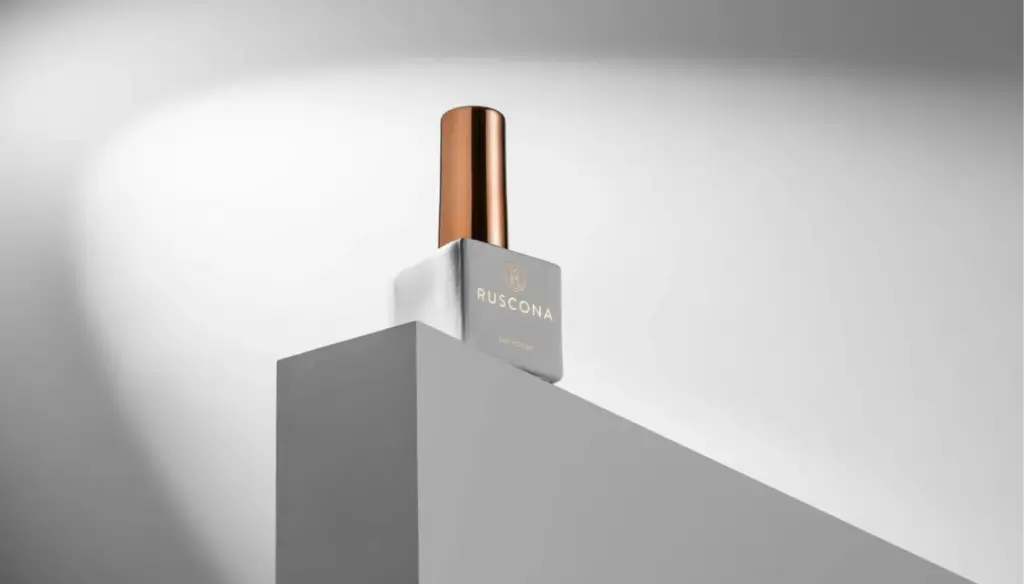 A polished product shot of a nail polish bottle on a minimalistic pedestal, showcasing its sleek design and elegant branding.
