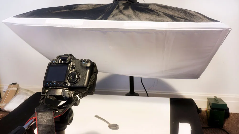 Camera and softbox setup for photographing silverware.