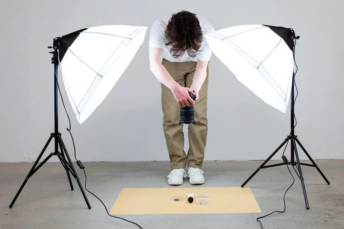 Photographer using umbrella lighting for product shoot