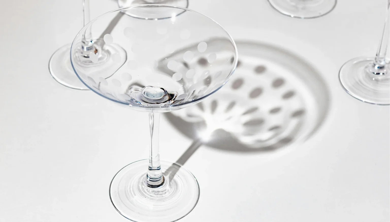 Clear glassware photographed with bright backlighting and soft shadows for transparent product photography.