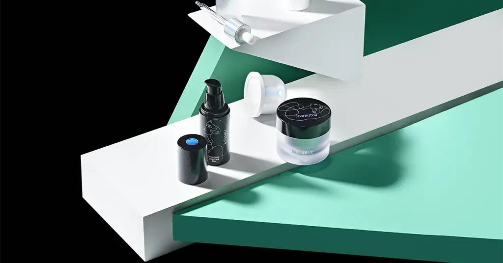 Creative cosmetic product photography with skincare bottles and jars arranged on bold geometric platforms.