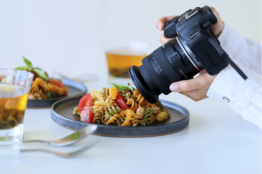 Product photographer capturing food details with a camera